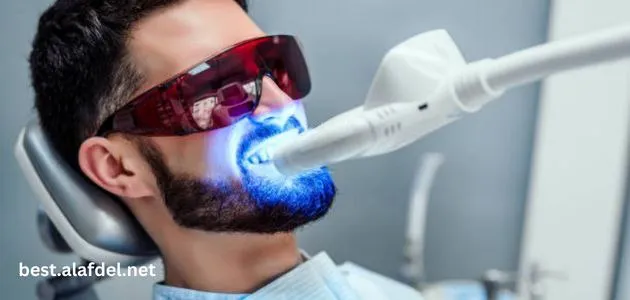 A picture of a man doing laser sessions on his teeth to get a white smile and clarify the applications of lasers in dentistry.