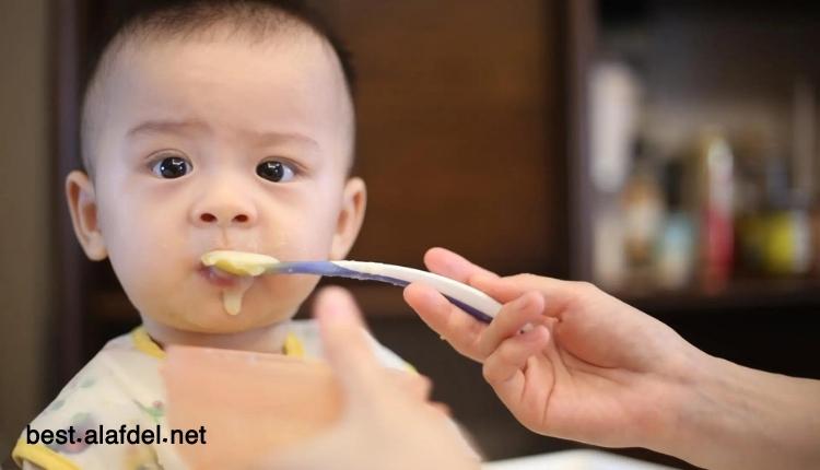 Image of a baby being fed with a spoon when talking about When to feed a newborn