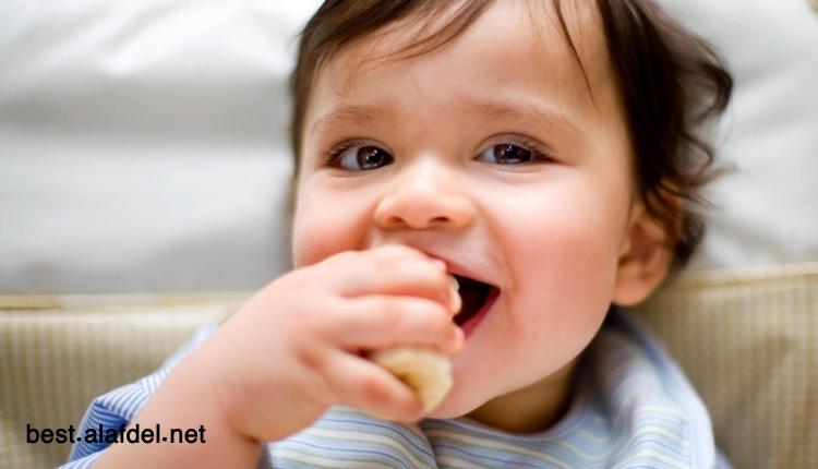 A picture of a baby being fed with a spoon when talking about From 6 to 8 Months Nutritional Guidelines